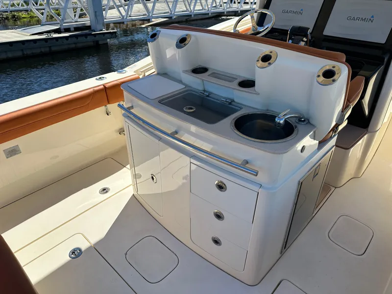 Slide: The Image of 2017 Scout 320 LXF boat interior with sink and storage compartments. - 8