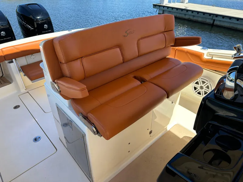 Slide: The Image of 2017 Scout 320 LXF boat with luxurious tan leather seating and dual Mercury engines. - 9