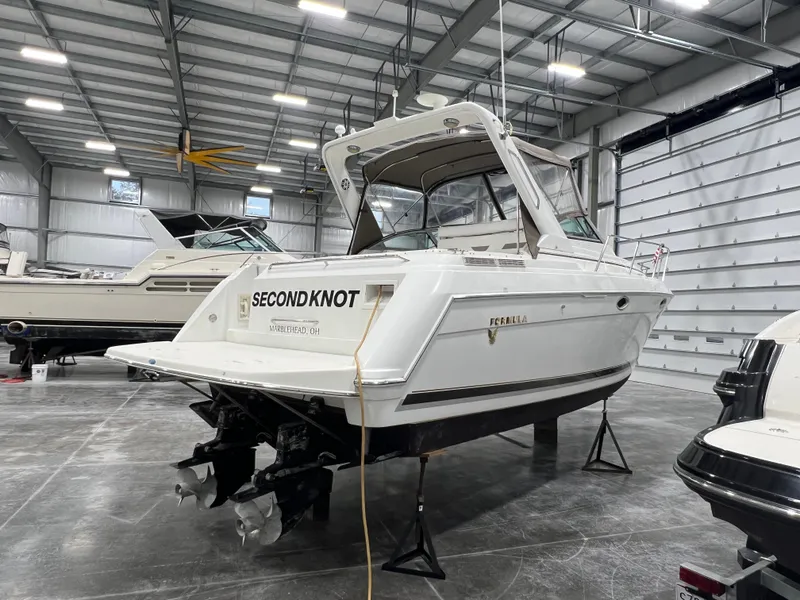 Slide: The Image of 2000 Formula 31 PC boat named "Second Knot" in a spacious indoor storage facility. - 1