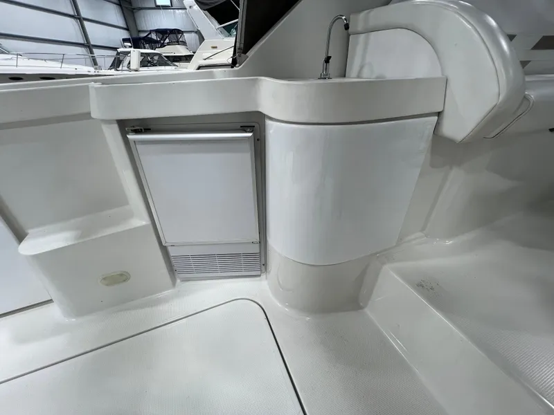 Slide: The Image of 2000 Formula 31 PC yacht interior with sink and mini fridge in a sleek, modern design. - 10