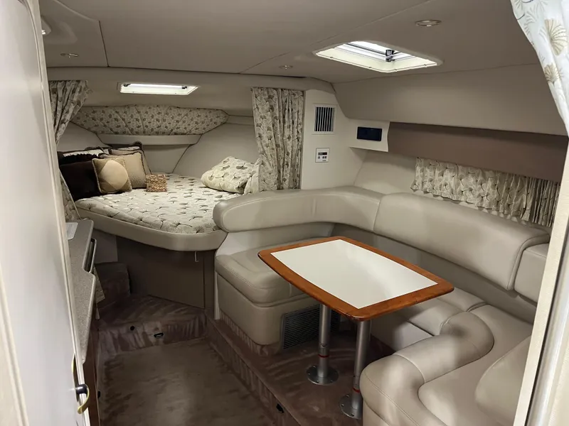 Slide: The Image of Interior of a 2000 Formula 31 PC boat with cozy seating and a dining area. - 13