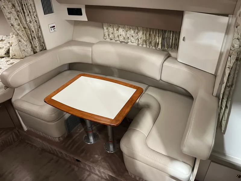 Slide: The Image of 2000 Formula 31 PC interior with beige leather seating and wooden table. - 14