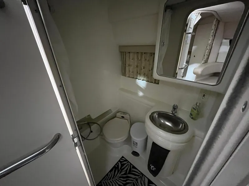 Slide: The Image of Bathroom interior of 2000 Formula 31 PC boat with sink, toilet, and mirror. - 17