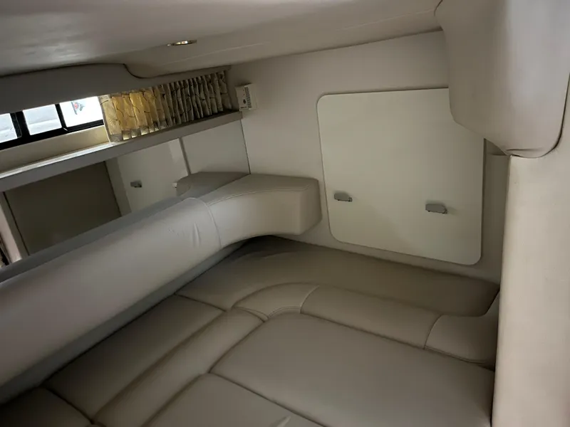 Slide: The Image of Interior cabin of a 2000 Formula 31 PC boat, featuring beige leather seating. - 19