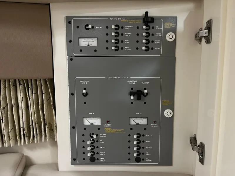 Slide: The Image of Electrical control panel inside a 2000 Formula 31 PC boat, featuring switches and gauges. - 20