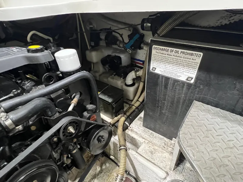 Slide: The Image of Engine compartment of a 2000 Formula 31 PC boat with oil discharge warning. - 24