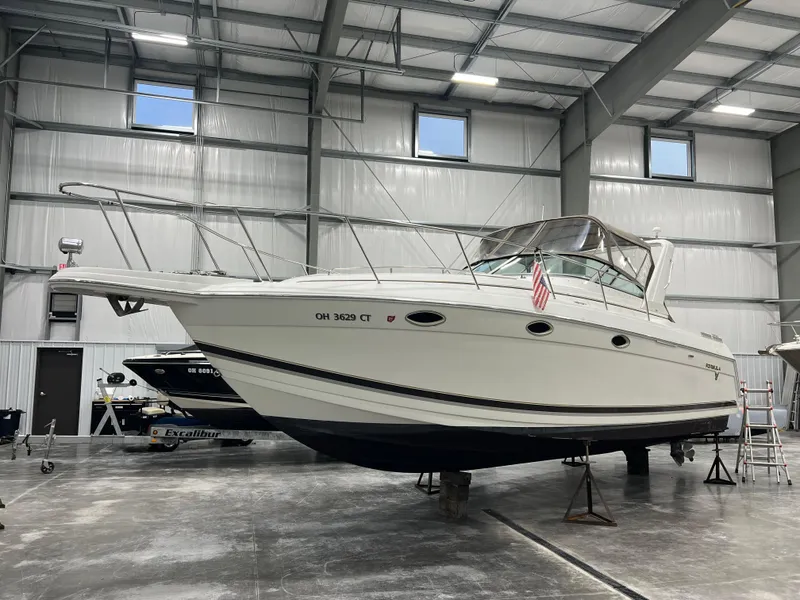 Slide: The Image of 2000 Formula 31 PC boat in indoor storage, elevated on stands. - 4