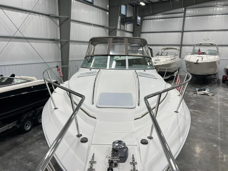 Slide: The Image of 2000 Formula 31 PC boat in storage, surrounded by other vessels in a spacious indoor facility. - 5