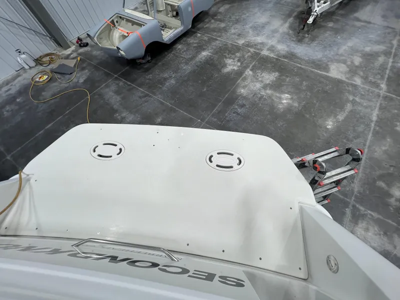 Slide: The Image of 2000 Formula 31 PC boat in a garage with equipment and tools. - 6