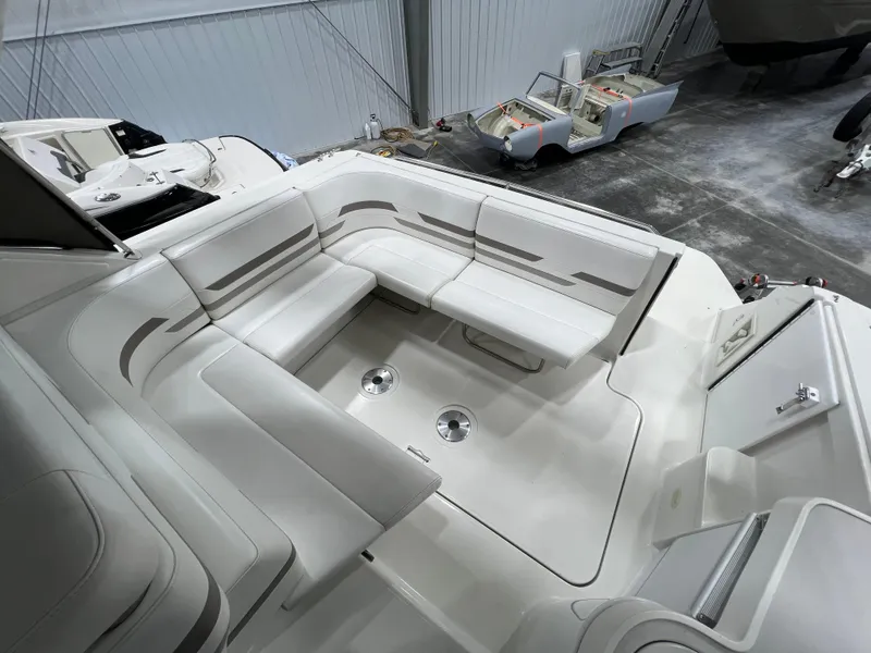 Slide: The Image of 2000 Formula 31 PC boat interior with spacious white seating area in a storage facility. - 8