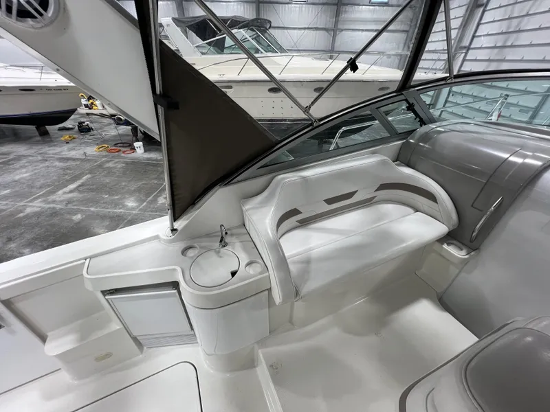 Slide: The Image of Interior view of a 2000 Formula 31 PC boat with white seating and cup holder. - 9