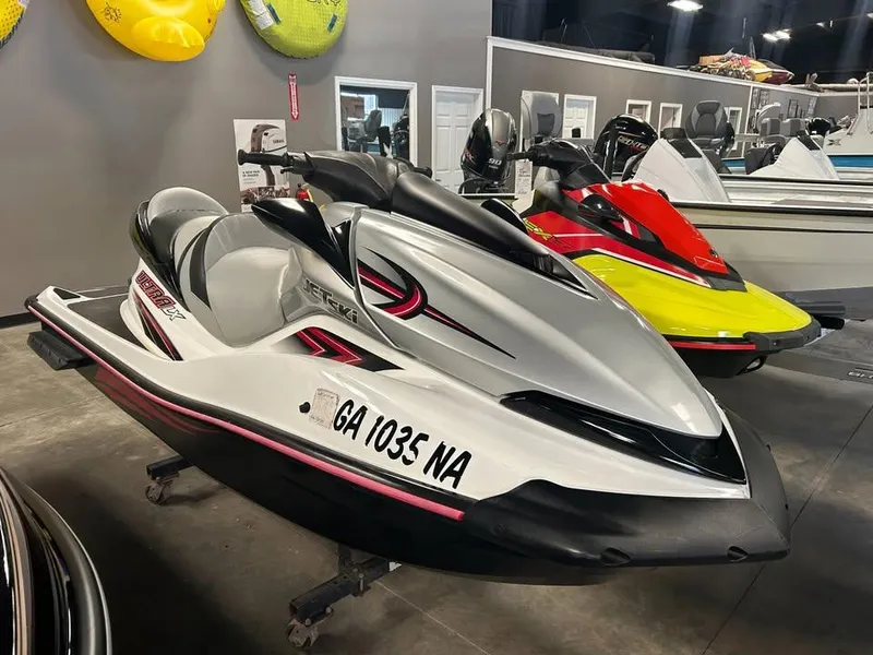 Slide: The Image of 2011 Kawasaki Jet Ski Ultra LX in showroom, white and black design, side view. - 1