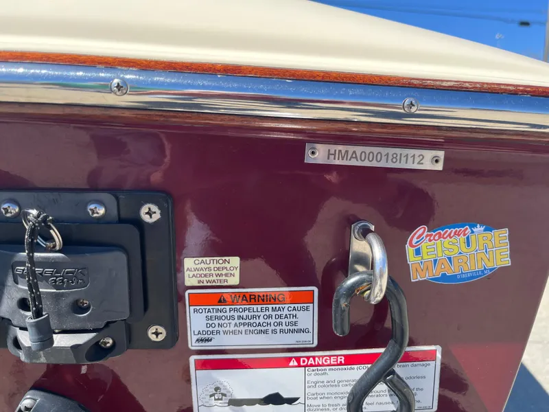 Slide: The Image of Hornet 17 HiPerformance 2012 boat stern with safety warnings and Crown Leisure Marine sticker. - 5