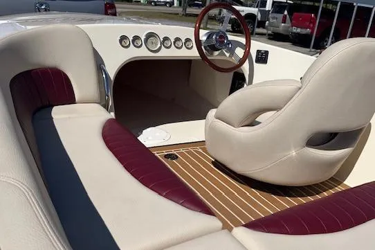 Slide: The Image of Interior of a 2012 Hornet 17 HiPerformance boat with plush seating and wooden accents. - 7