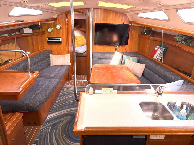 Slide: The Image of Interior of a 2005 Hunter 38 sailboat with cozy seating and modern amenities. - 12