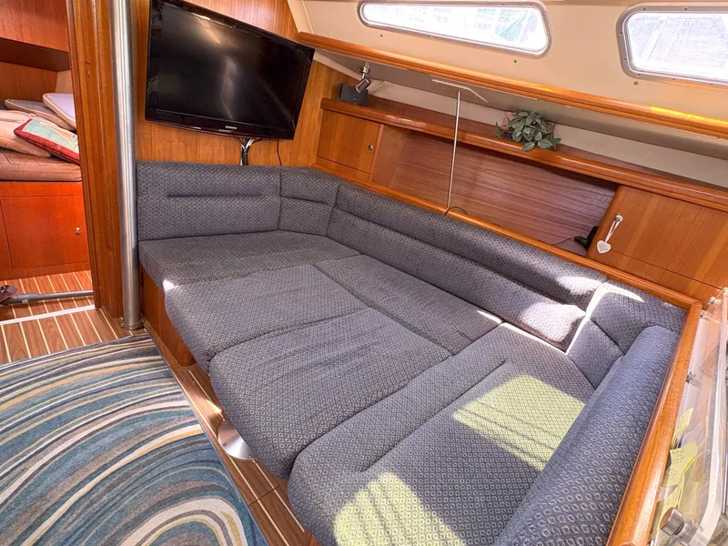 Slide: The Image of Interior of 2005 Hunter 38 sailboat with cozy seating and mounted TV. - 14