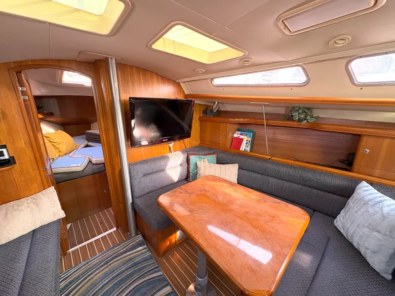 Slide: The Image of Interior of 2005 Hunter 38 sailboat with cozy seating and wooden table. - 16
