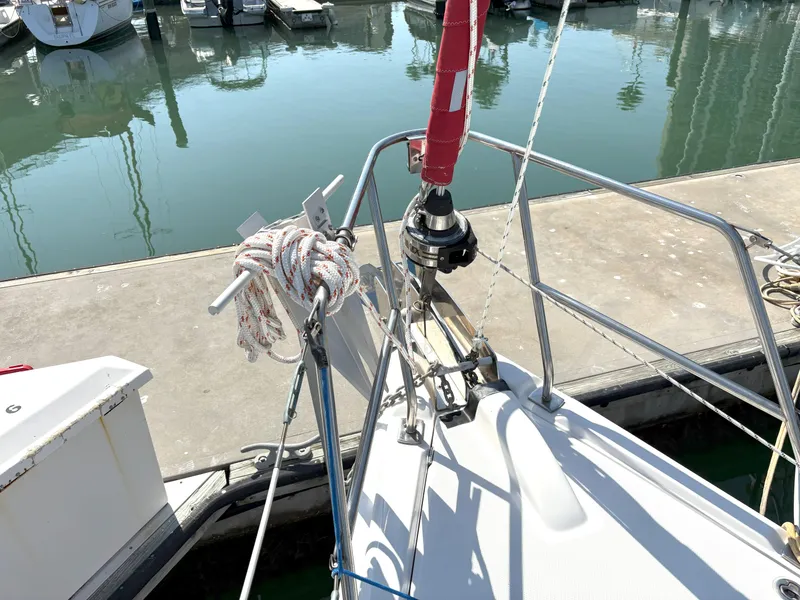 Slide: The Image of Sailboat bow at marina, Hunter 38 model, 2005, with docked boats in background. - 4