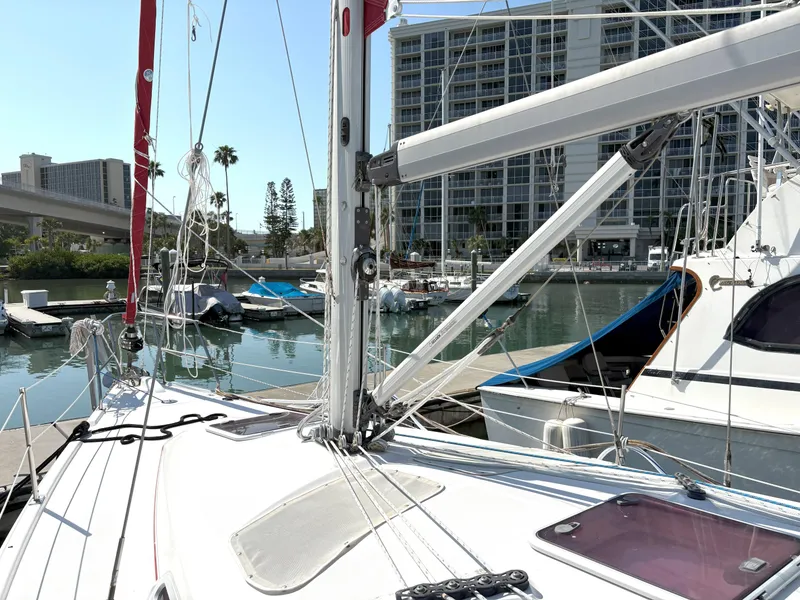 Slide: The Image of Sailboat docked in marina, Hunter 38 model, 2005, with cityscape background. - 6