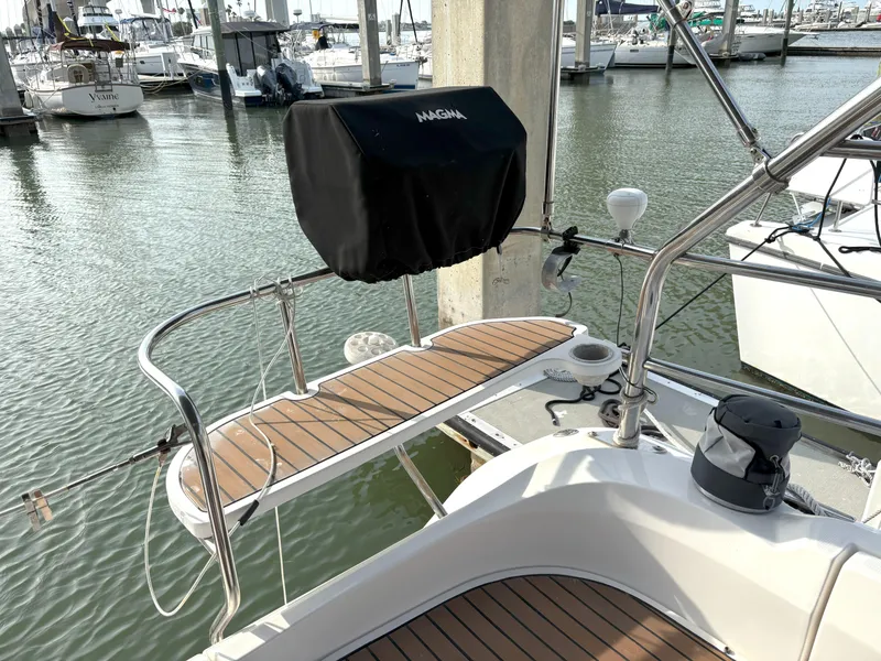 Slide: The Image of Hunter 38 sailboat stern with teak deck and covered grill, docked in marina, 2005 model. - 8