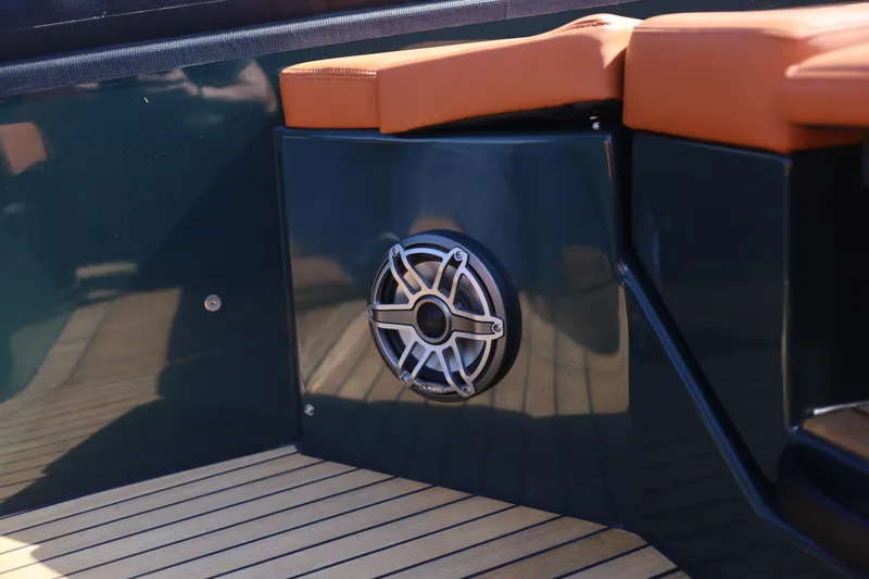 Slide: The Image of Speaker on Skipper-BSK 38 boat, 2025 model, with sleek seating and wooden deck. - 10