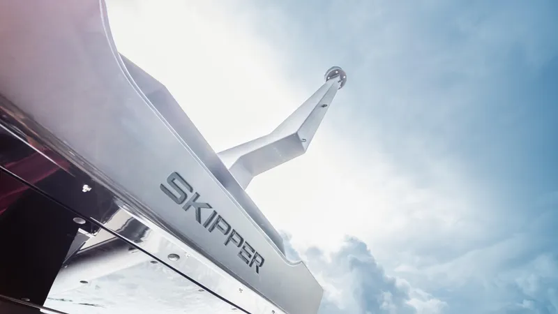 Slide: The Image of Skipper-BSK 38 boat, 2025 model, against a bright sky background. - 11