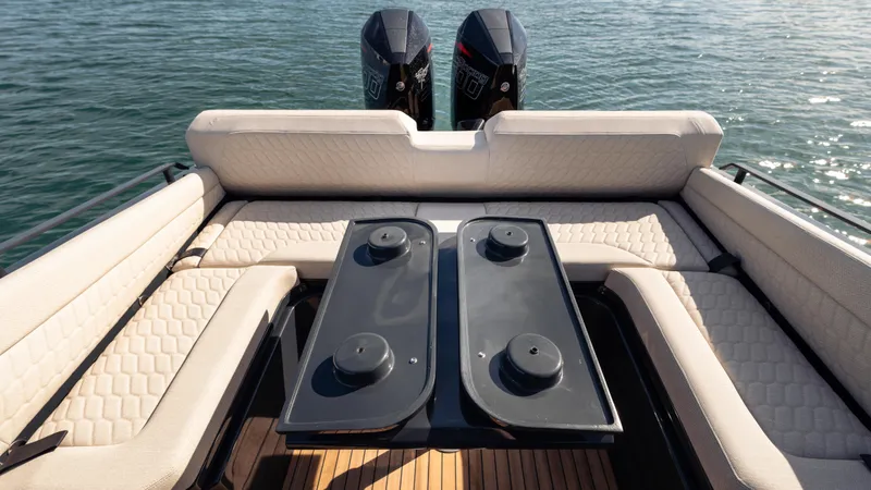 Slide: The Image of Luxurious seating area on Skipper-BSK 38 boat, 2025 model, with dual outboard motors. - 21