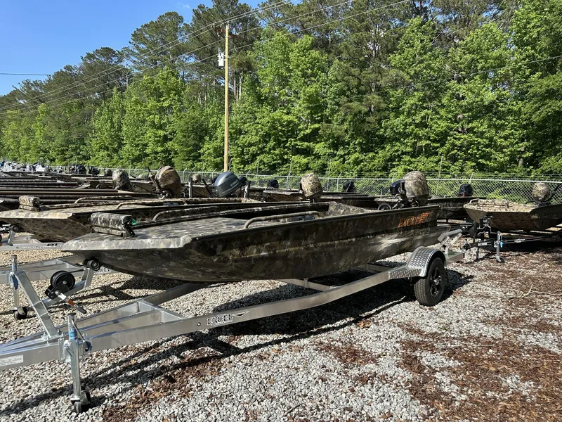 Slide: The Image of 2025 Excel Viper F4 1751 boats on trailers, parked outdoors with trees in the background. - 1