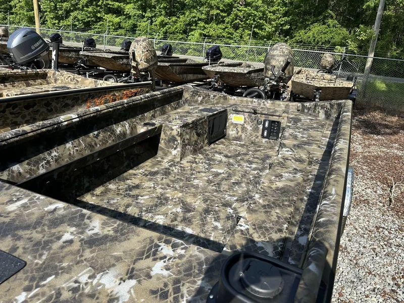 Slide: The Image of 2025 Excel Viper F4 1751 boat with camouflage design, parked outdoors. - 11