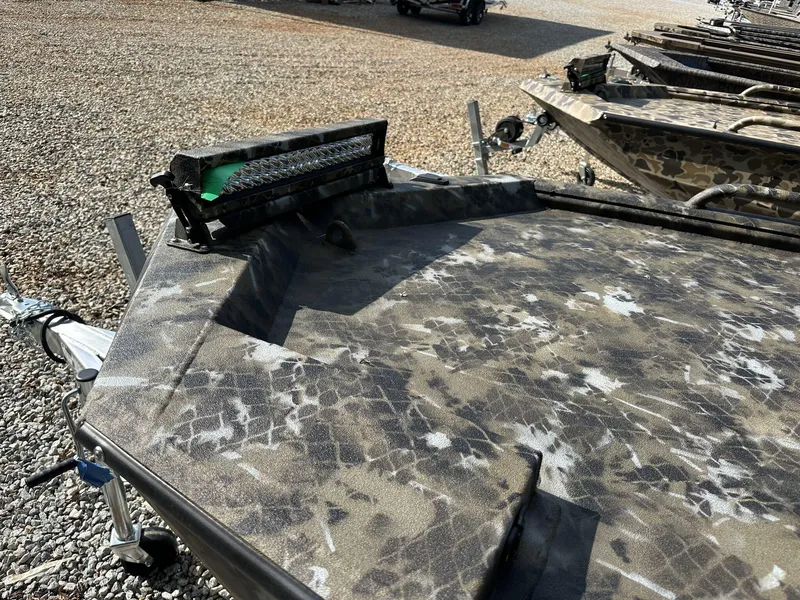 Slide: The Image of 2025 Excel Viper F4 1751 boat with camouflage pattern on gravel surface. - 12