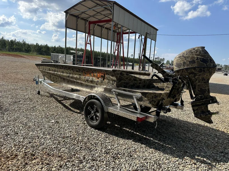 Slide: The Image of 2025 Excel Viper F4 1751 boat with camouflage design on a trailer, parked outdoors. - 11