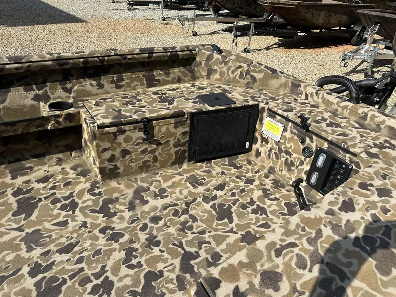 Slide: The Image of Camouflage interior of 2025 Excel Viper F4 1751 boat with control panel and storage. - 6