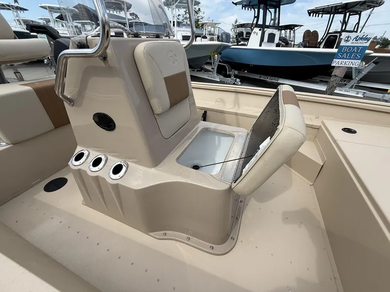 Slide: The Image of 2025 G3 Bay 17 boat interior with open storage compartment and rod holders. - 10