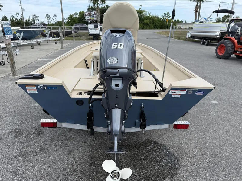 Slide: The Image of 2025 G3 Bay 17 boat with 60 HP motor, parked outdoors. - 3