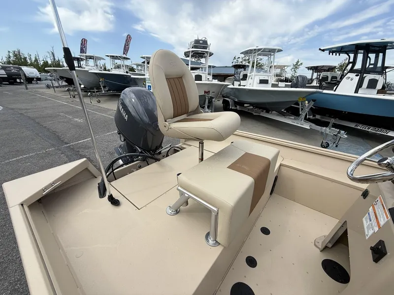 Slide: The Image of 2025 G3 Bay 17 boat with Yamaha motor, beige seating, and steering wheel, docked in marina. - 4