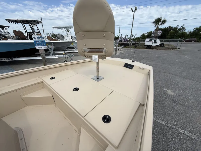 Slide: The Image of 2025 G3 Bay 17 boat interior with seating and storage, displayed at a sales lot. - 7