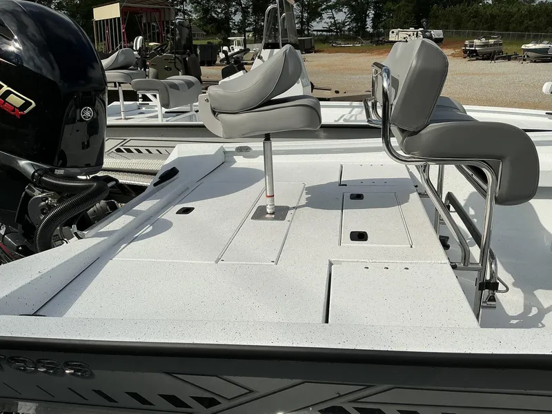 Slide: The Image of 2025 Xpress Hyper-Lift Series H22B boat with seating and Yamaha engine, in a sunny outdoor setting. - 12