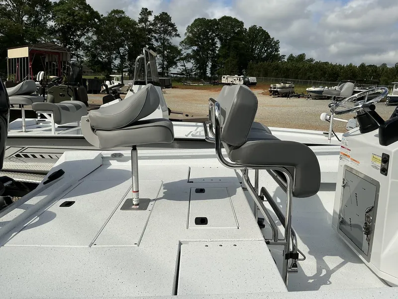 Slide: The Image of 2025 Xpress Hyper-Lift Series H22B boat with gray seating and control panel, outdoors. - 13