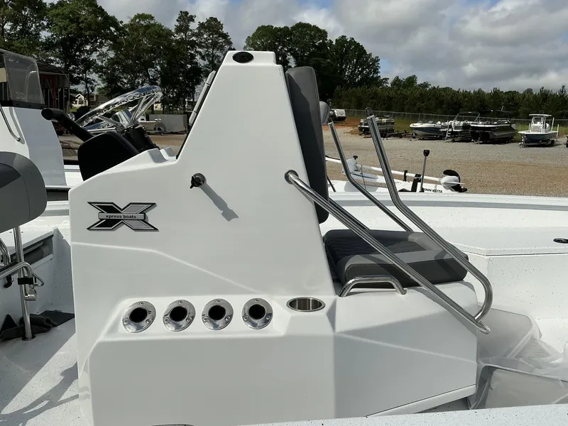 Slide: The Image of 2025 Xpress Hyper-Lift Series H22B boat console with seating, outdoors. - 9