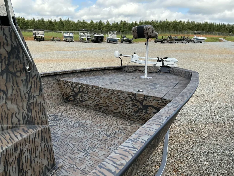 Slide: The Image of 2025 Xpress Hyper-Lift Bay Series 210 BAY-175 HP boat with camo design in a gravel lot. - 5