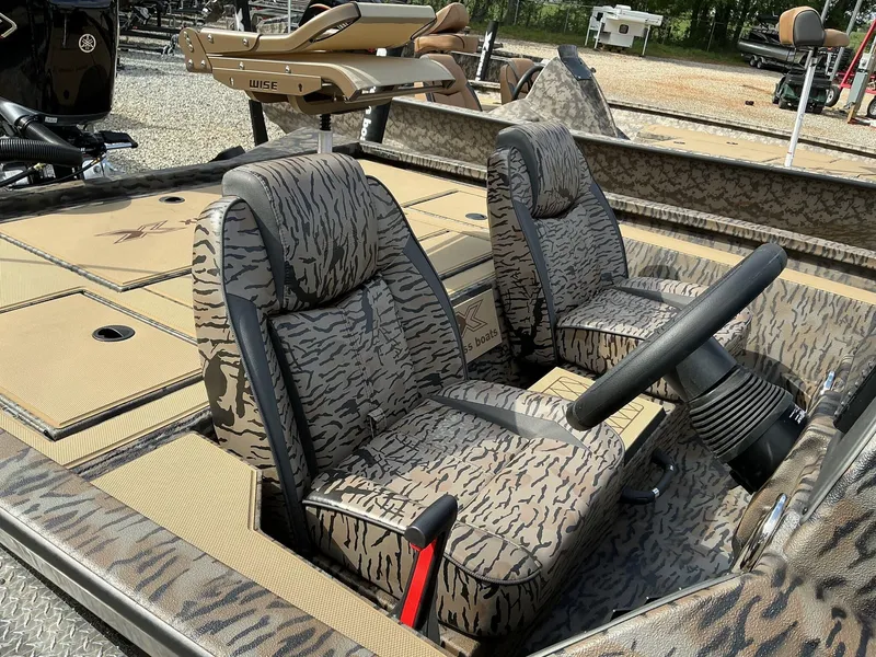 Slide: The Image of 2025 Xpress Hyper-Lift Crappie Series H20 boat with camo seats and steering wheel. - 5