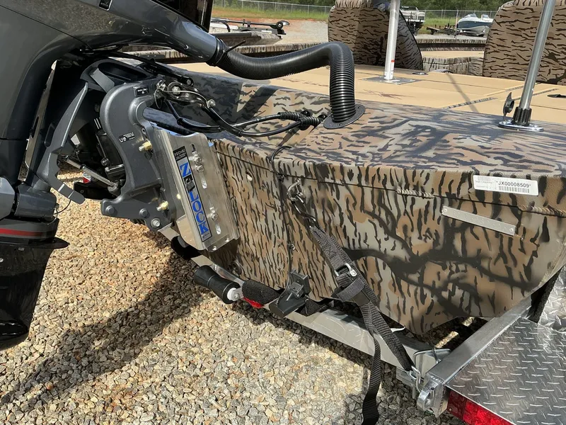 Slide: The Image of 2025 Xpress Hyper-Lift Crappie Series H20 boat with camo design on trailer. - 8