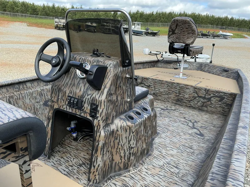 Slide: The Image of 2025 Xpress Xplorer Series XP20CC boat with camo interior and steering console. - 5