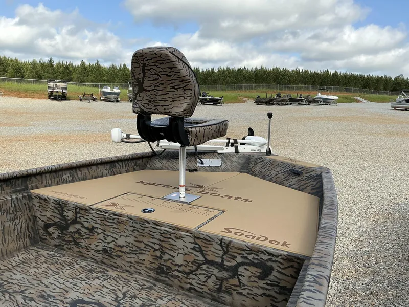 Slide: The Image of 2025 Xpress Xplorer Series XP20CC boat with camo design and SeaDek flooring. - 2