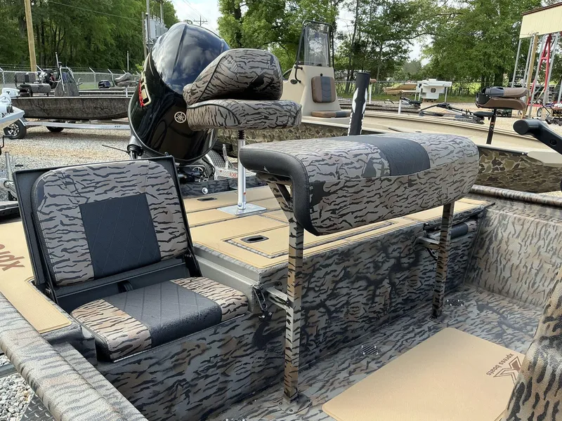 Slide: The Image of 2025 Xpress Xplorer Series XP20CC boat with camouflage seating and Yamaha engine. - 4