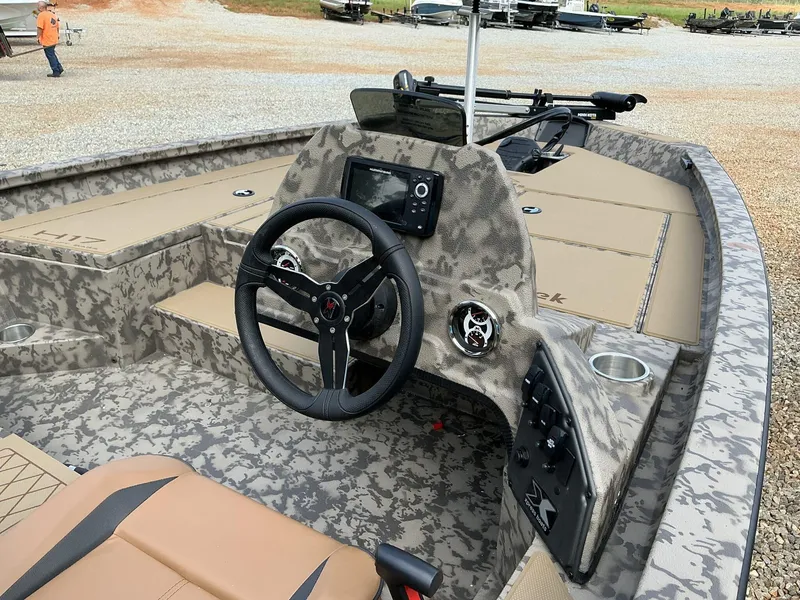 Slide: The Image of 2025 Xpress Hyper-Lift Bass Series boat interior with camo design and modern controls. - 3