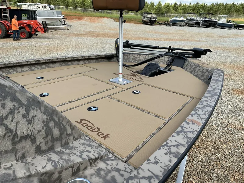 Slide: The Image of 2025 Xpress Hyper-Lift Bass Series boat with SeaDek flooring, parked outdoors. - 4