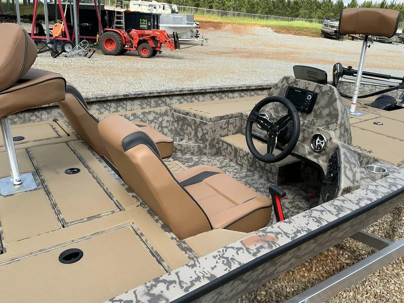 Slide: The Image of 2025 Xpress Hyper-Lift Bass Series boat interior with steering console and seating. - 7