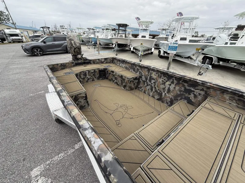 Slide: The Image of 2025 Thor Lake Hammer 1754 boat with Seadeck, camo design, parked among other boats. - 6