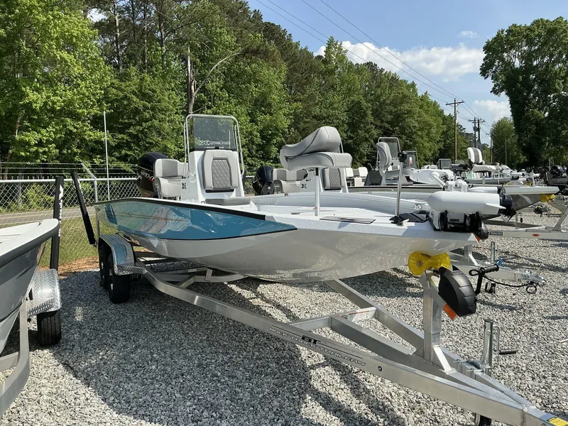 Slide: The Image of 2025 Xpress Hyper-Lift Series H22B boat on trailer, surrounded by trees and clear sky. - 1